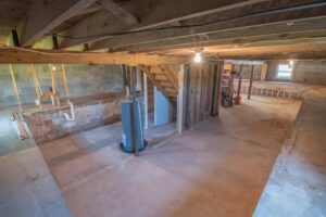 Unfinished basement with stairs leading to the main level | Structural Damage | Once and Done Waterproofing | WV, MD, NJ, PA