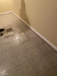 Wet basement tiles bubbling from water | Wet Basement | Once and Done Waterproofing | WV, MD, NJ, PA