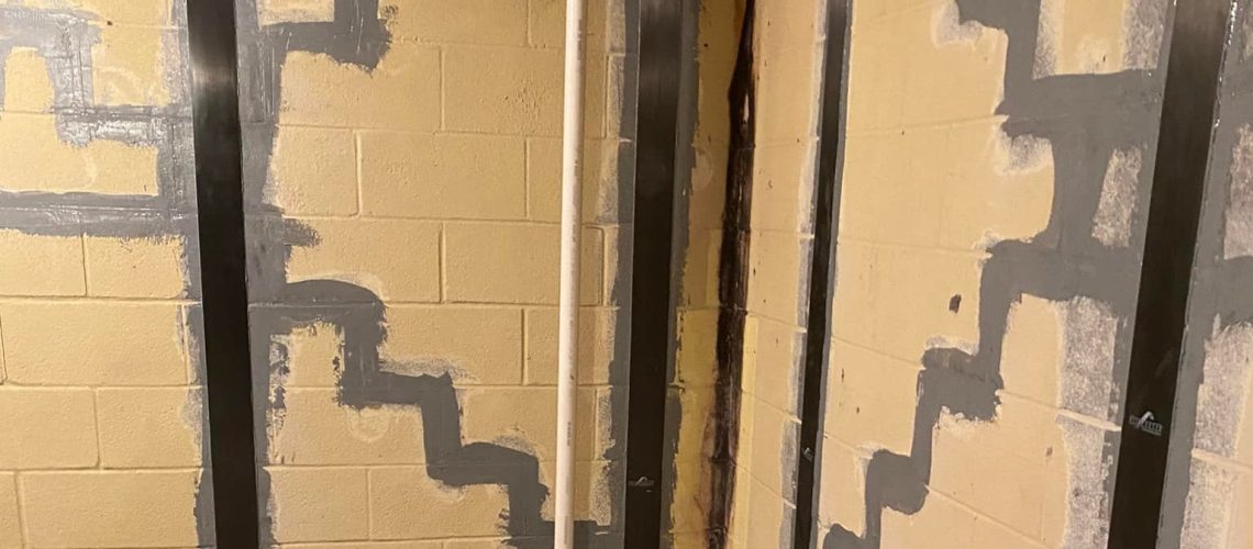 Basement wall with cracks in the walls filled in and fixed | Foundation Cracks | Once and Done Waterproofing
