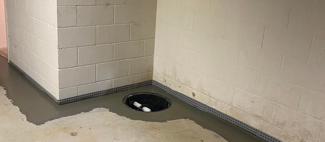 Sealed basement floor with a sump pump | Basement Leaks | Once and Done Waterproofing
