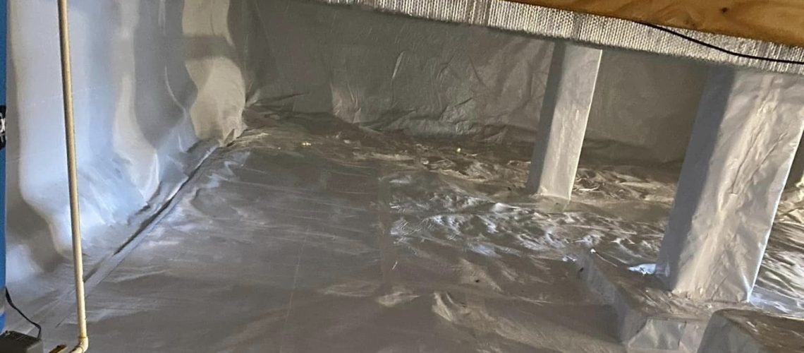 Encapsulated crawl space with white plastic wrap around the floors and walls to keep water out | Flooded Crawl Space | Once and Done Waterproofing