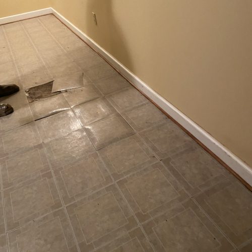 Wet basement tiles bubbling from water | Wet Basement | Once and Done Waterproofing | WV, MD, NJ, PA