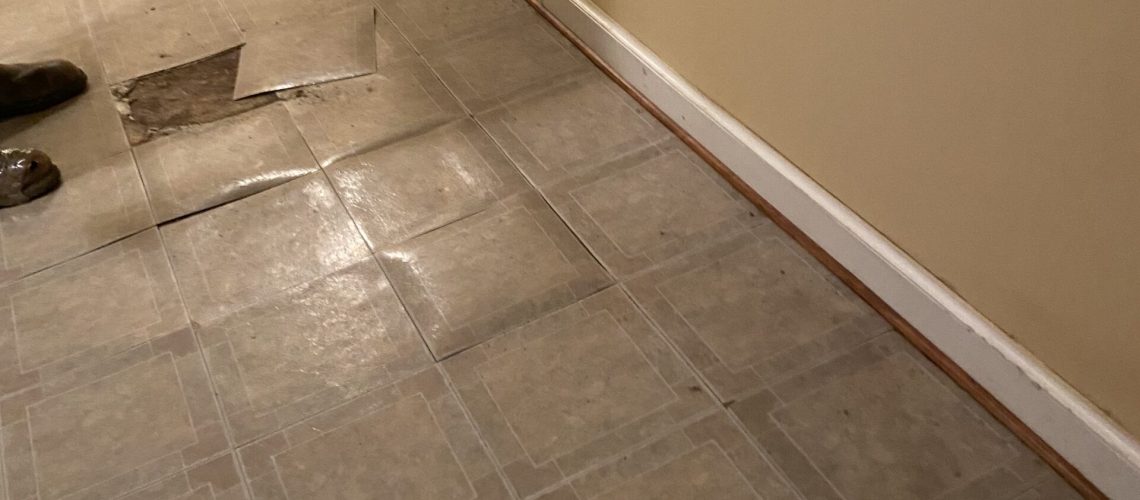 Wet basement tiles bubbling from water | Wet Basement | Once and Done Waterproofing | WV, MD, NJ, PA